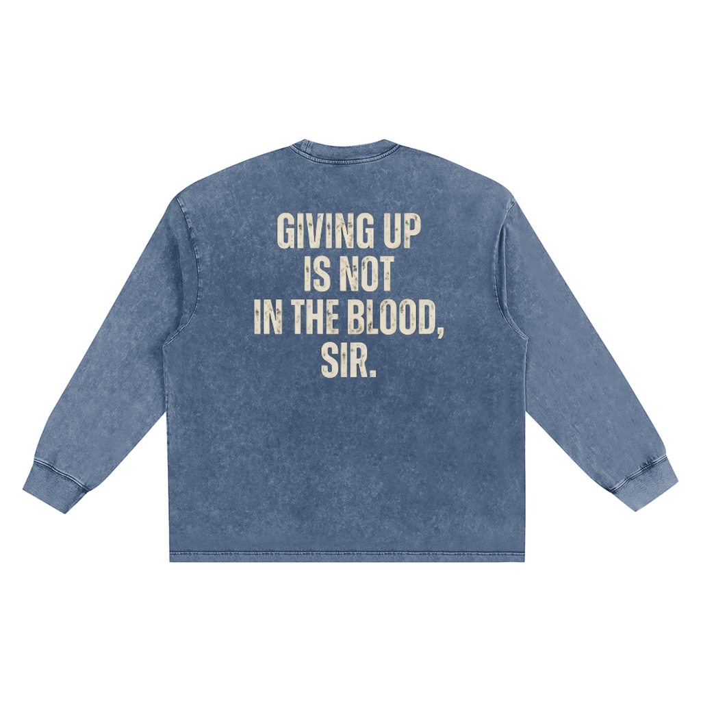A blue acid-wash long-sleeve t-shirt shown from the back, featuring the text 'GIVING UP IS NOT IN THE BLOOD, SIR.' printed in a distressed cream-colored font.